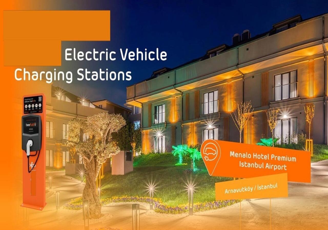 Menalo Hotel Premium Istanbul Airport Exterior photo The image showcases a well-lit scene featuring an electric vehicle charging station. To the side, there is a charging unit prominently displayed. In the background, you can see a hotel (Menalo Hotel Premium) located near Istanbul Airport, which is il